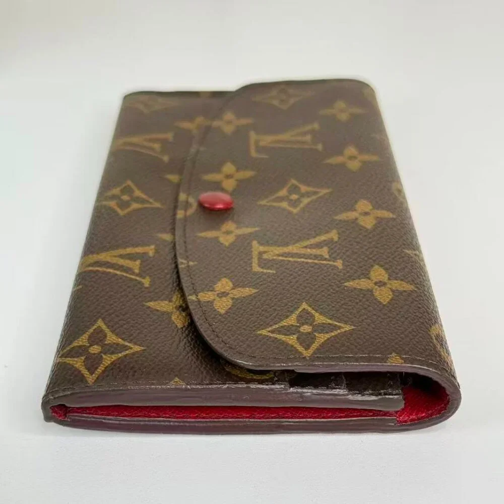 Louis Vuitton Monogram Canvas Wallet with Classic Design and Red Pin Detail